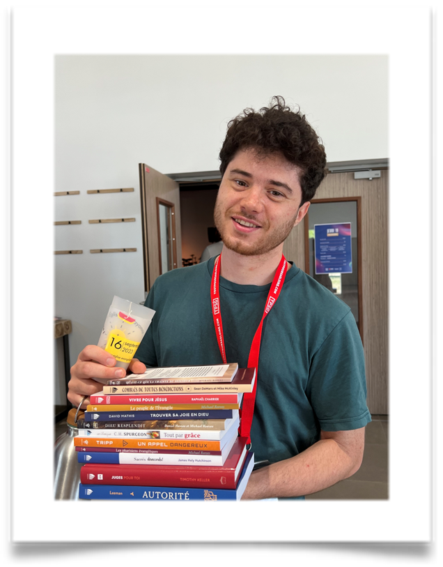 A pastor holds books given to him from CIO